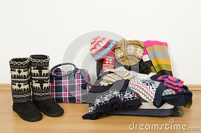 Winter luggage. Suitcase full of wither clothes. Stock Photo