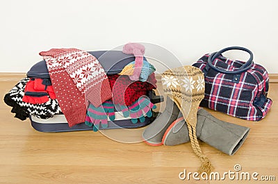 Winter luggage. Suitcase full of wither clothes. Stock Photo