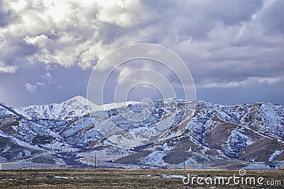 Winter Panorama of Oquirrh Mountain range snow capped, which includes The Bingham Canyon Mine or Kennecott Copper Mine, rumored th Stock Photo