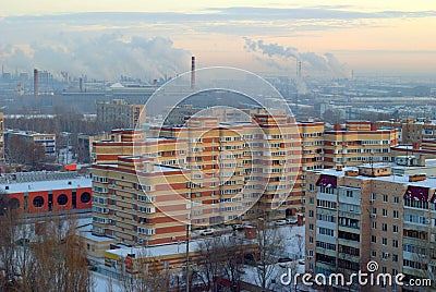 Winter panorama of residential areas of the city of Togliatti and smoking chimneys of chemical plants. Stock Photo