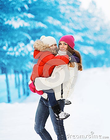 Winter and people concept - young mother and child walking winter Stock Photo