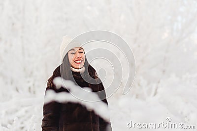 Winter photo shoot of a young woman.wide white-toothed smile, laugh with your eyes closed Stock Photo