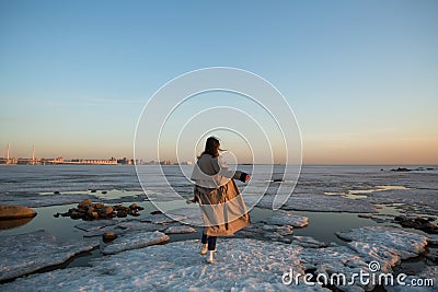 Winter photoshoot woman on the shore of the Gulf of Finland in St. Petersburg Stock Photo