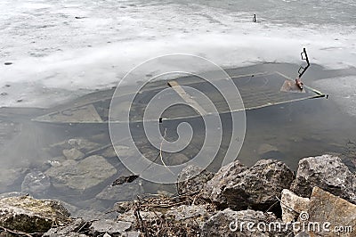 Winter pond with old sunken boat Stock Photo