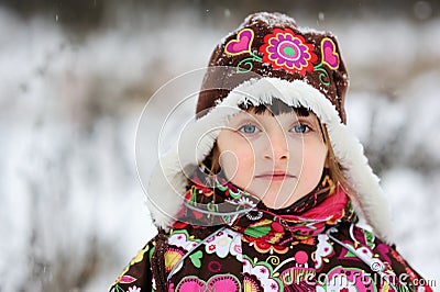 Winter portrait of child girl in snowsuit Stock Photo