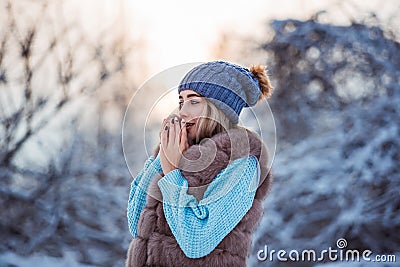Winter portrait of young beautiful woman wearing warm clothes. Snowing winter beauty fashion concept Stock Photo