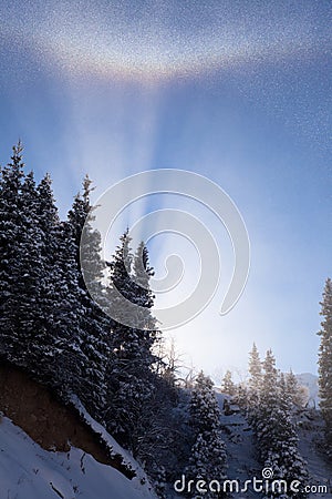 Winter rainbow in the mountains Stock Photo