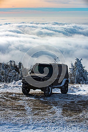 Winter ravel concept with 4x4 car. Offroad winter car. Adventure travel. Off-road travel on snow mountain road. Stock Photo