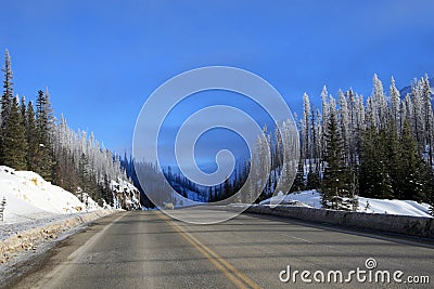 Winter road in Canadian Rockies Stock Photo