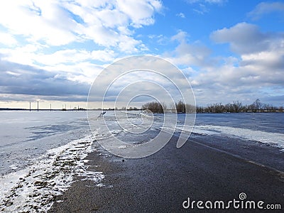 Winter road in flood time, Lithuania Stock Photo