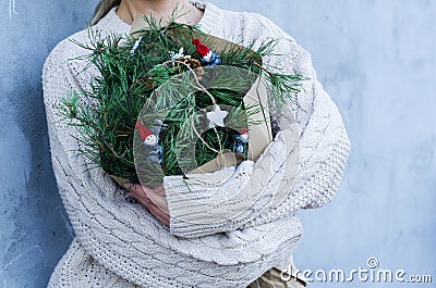 Winter rustic bouquet with fir branches. Female hands holding a Christmas bouquet. New year Stock Photo