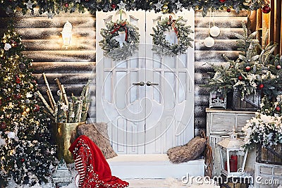 Winter rustic interior decorated for New year with artificial snow and Christmas tree. Winter exterior of a country Stock Photo