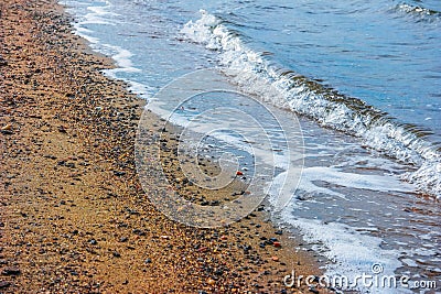 A winter scene of the bay and Sandy shoreline and waves at ebbtide Stock Photo