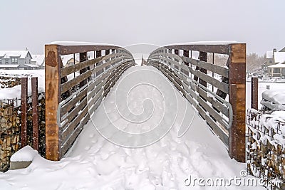 Winter scene with footsprints on the snowy bridge Stock Photo