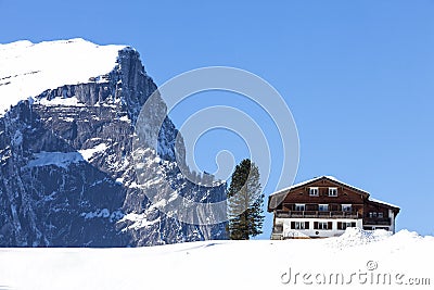 Winter scenery in the Austrian Alps, wooden chalet in the snow Stock Photo