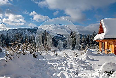 Rural wooden cottage on the background of snow-capped mountains, Zakopane, Poland Stock Photo