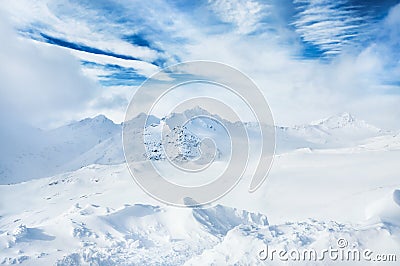 Winter snow-covered mountains and blue sky with white clouds Stock Photo
