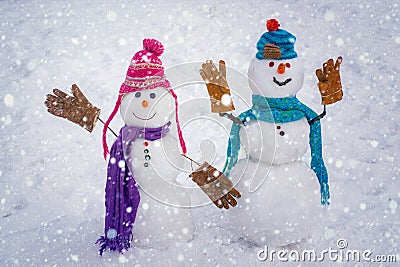 Winter snow decorating. Snowman couple enjoying intimacy. Funny Laughing Surprised snowman Portrait. Winter Love story Stock Photo
