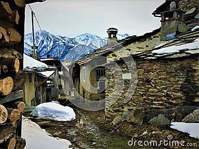 Winter, snow, path, wood, town and mountains Stock Photo