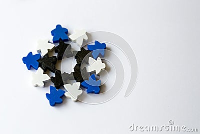 winter snowflake made of meeples - components of strategy board game on white background with copyspace. Game playing with friends Stock Photo