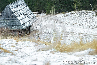 Winter snowy landscape with traditional log cabin and shake roof in forest Stock Photo