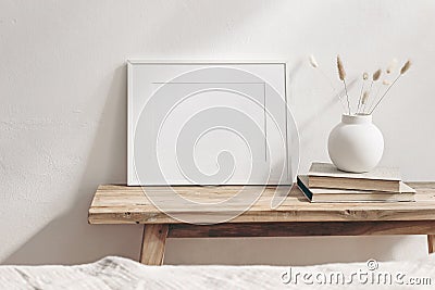 Winter still life. Horizontal white frame mockup on vintage wooden bench, table. Modern white ceramic vase with pine Stock Photo