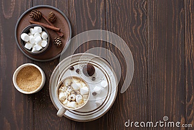 Winter still life- cup of coffee, marshmallows and fir cones on dark wooden background Stock Photo