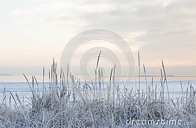 Winter sunset by the beach, icy sea Stock Photo