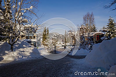 A winter tale - a sunny day for Christmas. Snow-covered streets, houses, sun rays, people walking along the pedestrian zone. ski Editorial Stock Photo