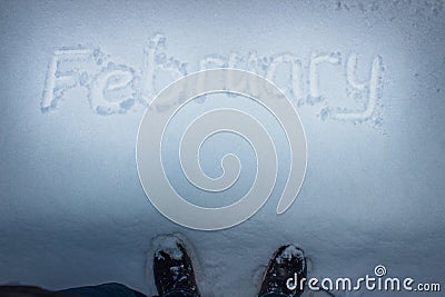 February handwritten on fresh snow Stock Photo