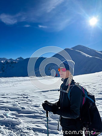 Winter trekker pausing in the serene expanse of the Polish Tatras Stock Photo