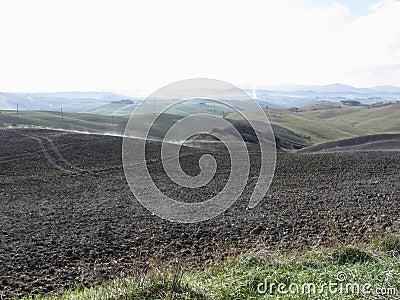 Winter Tuscany landscape with plowed fields at morning mist Stock Photo