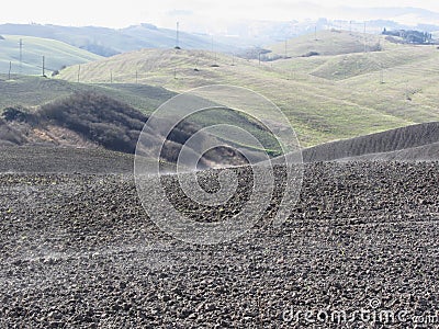 Winter Tuscany landscape with plowed fields at morning mist Stock Photo