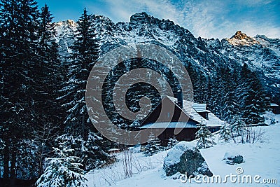 Winter vacation holiday wooden house in the mountains covered with snow and blue sky Stock Photo