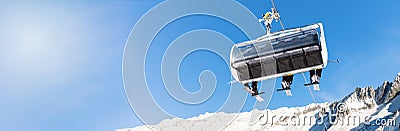 winter vacation - skiers in a chairlift against blue sky Stock Photo