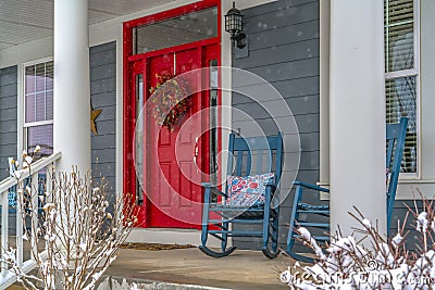 Winter view of home with red door and front porch Stock Photo