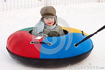 Winter walk, boy rides a Snow-tubing Stock Photo