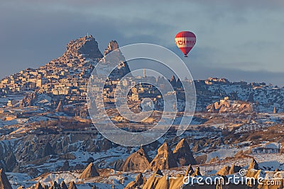 Winter warm dawn with red balloon on hotfire balloons festival, cappadocia, turkey, kappadokya Editorial Stock Photo