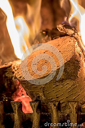 Winter warmth. Birch wood log burning on an open fire Stock Photo