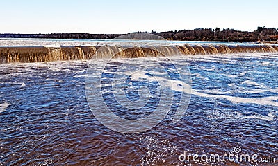 Winter water and ice flowing over Mohawk River dam Stock Photo