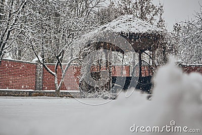 Winter, white fluffy snow lies on the ground. The gazebo and trees are strewn with snow. Soft selective selective frocus. New Year Stock Photo