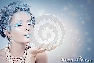 Winter Woman Fashion Model Blowing Snow at Night Stock Photo