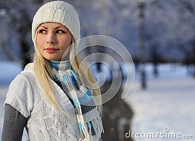 Winter woman with knitted hat and scarf over alley trees Stock Photo
