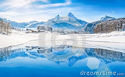 Winter wonderland in the Alps reflecting in crystal clear mountain lake Stock Photo