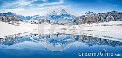 Winter wonderland in the Alps reflecting in crystal clear mountain lake Stock Photo