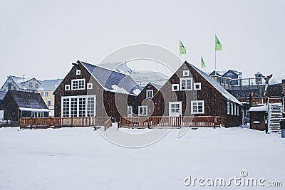 Winter wonderland snow panorama typical traditional wooden house building waterfront in Husavik Northern Iceland Europe Stock Photo