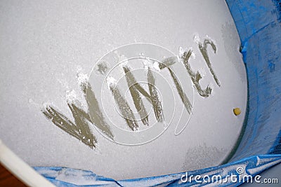 Winter written on the frozen outdoor swimming pool Stock Photo