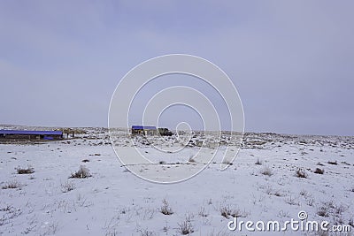 Wintering. Winter `kishlak`. Winter wintering. Distant pasture. View in winter. White background. Stock Photo