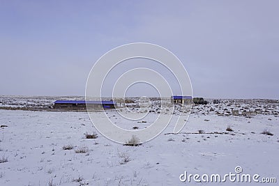 Wintering. Winter `kishlak`. Winter wintering. Distant pasture. View in winter. White background. Stock Photo