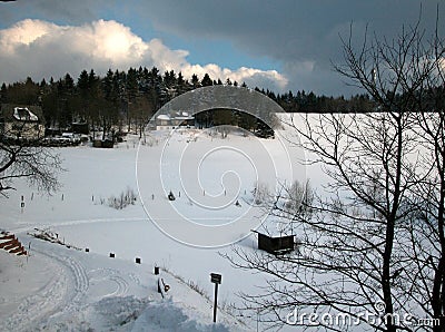 A winterlandscape with dark cloud, snow and small slope Stock Photo